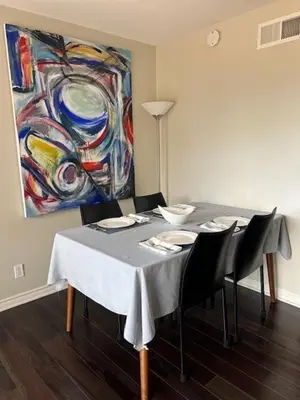 a dining room with a table with chairs and a painting at Viewpoint Villa - VILLA105 in Solana Beach