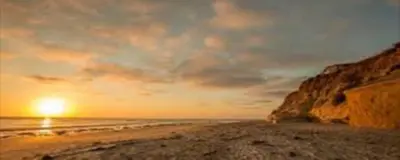 a sunset on a beach with the ocean at Viewpoint Villa - VILLA105 in Solana Beach