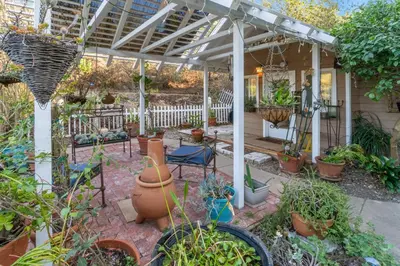 a patio with potted plants and a white pergola at Buena Creek Refuge - Family Resort Destination - Secure and Private - in Vista