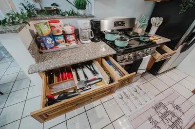 a kitchen with a counter with wooden drawers at Entire Private Home with 4 Bedrooms 2 Bathrooms, Garage & Gated Yard, Near San Diego Gaslamp, Beach, Available Now in National City