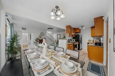 a kitchen and living room with a table with dishes at Entire Private Home with 4 Bedrooms 2 Bathrooms, Garage & Gated Yard, Near San Diego Gaslamp, Beach, Available Now in National City