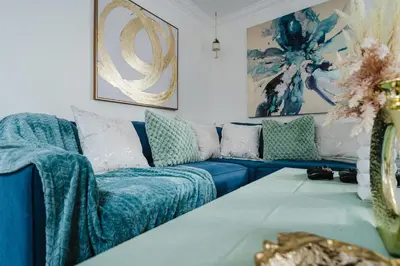 a living room with a blue couch with pillows at Entire Private Home with 4 Bedrooms 2 Bathrooms, Garage & Gated Yard, Near San Diego Gaslamp, Beach, Available Now in National City