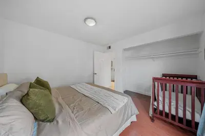 a bedroom with a bed and a crib at Entire Private Home with 4 Bedrooms 2 Bathrooms, Garage & Gated Yard, Near San Diego Gaslamp, Beach, Available Now in National City