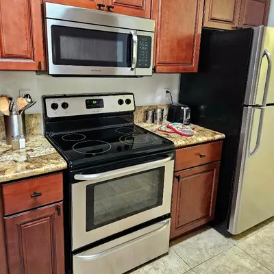 a kitchen with a stove and a microwave at Wine Country Reserves in Murrieta