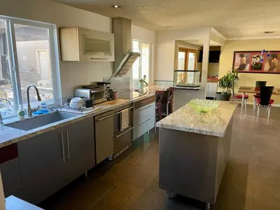a kitchen with a sink and a counter top at Rooms in Bay Park, San Diego in San Diego