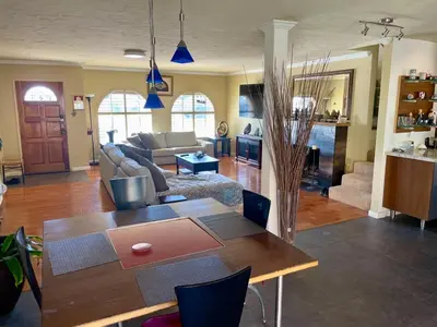 a living room with a table and a couch at Rooms in Bay Park, San Diego in San Diego
