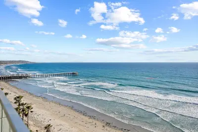 a view of a beach with a pier and the ocean at Oceanfront Paradise with Sunset Balcony, Pool, Spa, Beach Access and Parking in San Diego