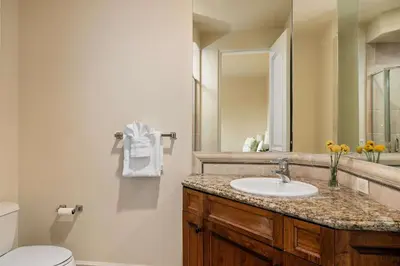 a bathroom with a sink and a toilet and a mirror at 7BR Carlsbad Estate with Pool Firepit & Views in Carlsbad