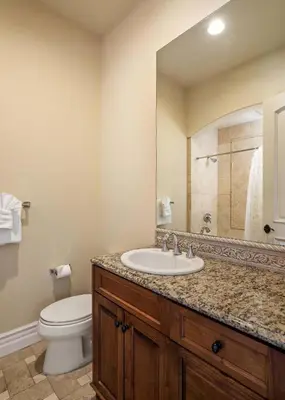a bathroom with a sink and a toilet and a mirror at 7BR Carlsbad Estate with Pool Firepit & Views in Carlsbad