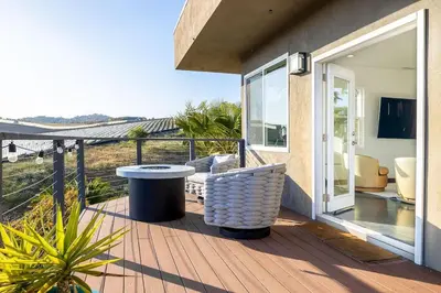 a patio with a table and chairs on a deck at Large Home With Sauna in Vista