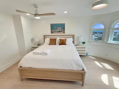 a bedroom with a large bed and two windows at F-72 Terramar Cliffs in Carlsbad