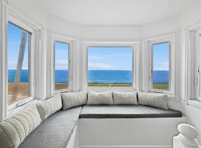 a white room with a couch in front of windows at F-75 Terramar Cliffs in Carlsbad