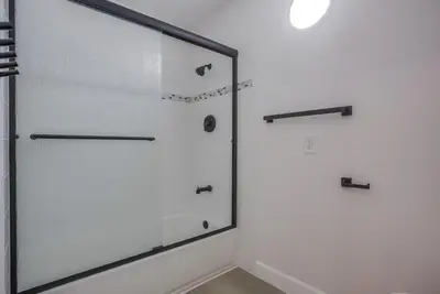 a glass shower door in a white bathroom at F-78 Seaside Escape in Encinitas