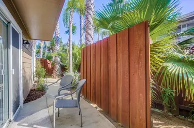 a chair sitting on a porch next to a fence at F-78 Seaside Escape in Encinitas