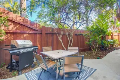 a patio with a table and a grill and chairs at F-78 Seaside Escape in Encinitas