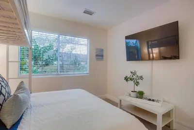 a bedroom with a bed and a tv on the wall at F-78 Seaside Escape in Encinitas
