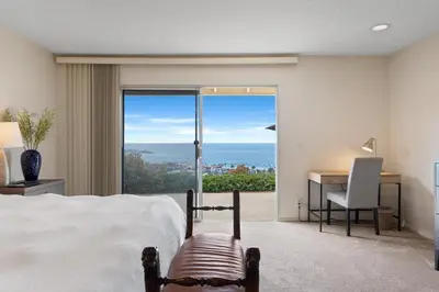 a bedroom with a bed and a desk and a window at La Jolla Shores Views in San Diego