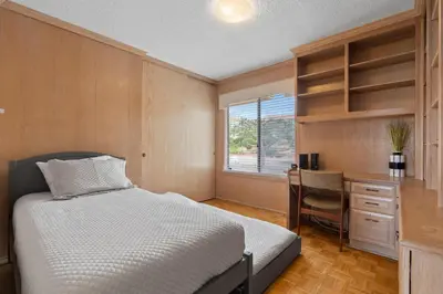a bedroom with a bed and a desk and a window at La Jolla Shores Views in San Diego
