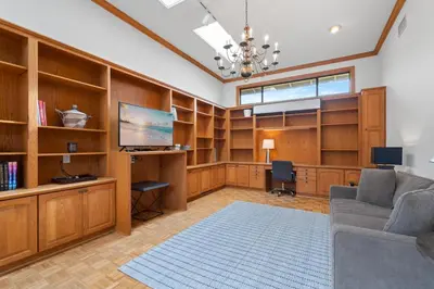 a living room with wooden book shelves and a couch at La Jolla Shores Views in San Diego