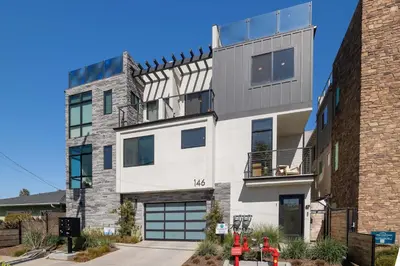 an apartment building with a balcony on top of it at Walk to the Beach & Pier Ocean View Roof Deck in Oceanside