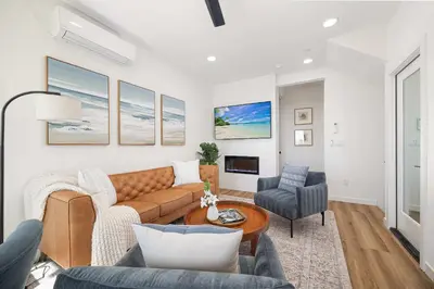 a living room with a couch and a table at Walk to the Beach & Pier Ocean View Roof Deck in Oceanside