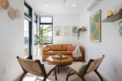 a living room with a couch and a table and chairs at Walk to the Beach & Pier Ocean View Roof Deck in Oceanside