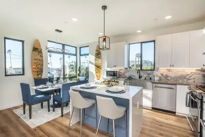 a kitchen and dining room with a table and chairs at Ocean View Roof Deck - Walk to the Beach & Pier in Oceanside