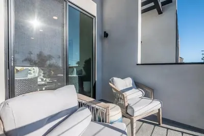 a balcony with two chairs and a mirror at Ocean View Roof Deck - Walk to the Beach & Pier in Oceanside