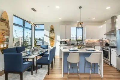 a kitchen and dining room with a table and chairs at Ocean View Roof Deck - Walk to the Beach & Pier in Oceanside
