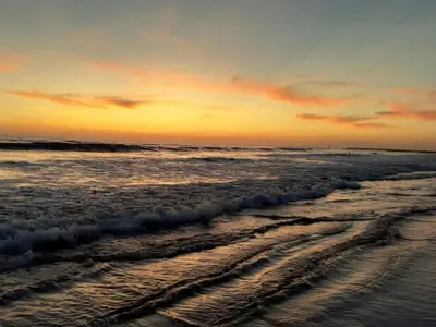 a view of the ocean at sunset at Ocean View Roof Deck - Walk to the Beach & Pier in Oceanside