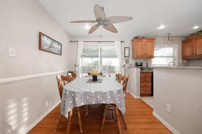 a dining room with a table and a ceiling fan at Walk to the Beach Private Backyard and Fire Pit in Oceanside