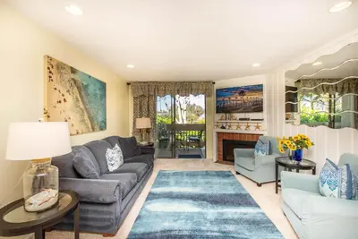 a living room with a couch and a table at Steps to the Beach 2 Pools & Hot Tubs - A-204 in Oceanside