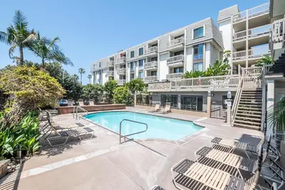 a swimming pool in front of a apartment building at Steps to the Beach 2 Pools & Hot Tubs - A-204 in Oceanside