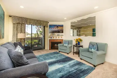 a living room with a couch and two chairs and a fireplace at Steps to the Beach 2 Pools & Hot Tubs - A-204 in Oceanside