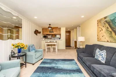 a living room with a couch and a table at Steps to the Beach 2 Pools & Hot Tubs - A-204 in Oceanside