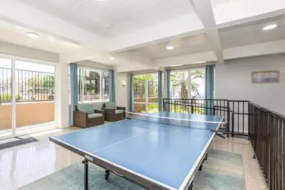 a large room with a ping pong table in it at Walk to the Beach Sunset Ocean Views - D-207 in Oceanside