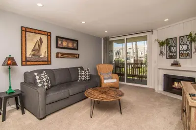 a living room with a couch and a fireplace at Walk to the Beach Sunset Ocean Views - D-207 in Oceanside