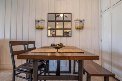 a dining room table with a mirror and a chair at Walk to the Beach Sunset Ocean Views - D-207 in Oceanside