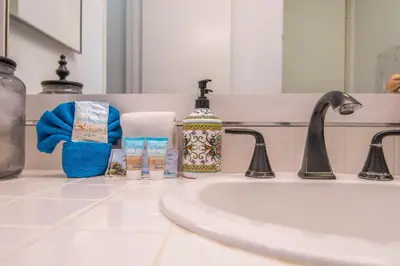 a bathroom counter with a sink and a mirror at Walk to the Beach Sunset Ocean Views - D-207 in Oceanside
