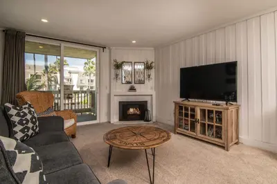 a living room with a tv and a fireplace at Walk to the Beach Sunset Ocean Views - D-207 in Oceanside