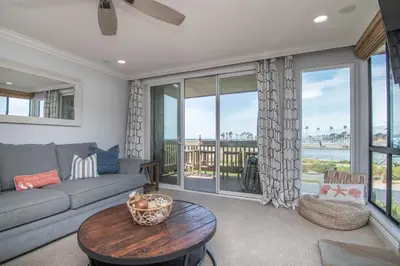 a living room with a couch and a table at Panoramic Water Views - Steps to the Beach - F-2 in Oceanside