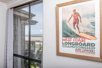 a poster of a man riding a wave on a surfboard at Panoramic Water Views - Steps to the Beach - F-2 in Oceanside