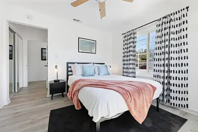 a white bedroom with a large bed and a window at Luxury Home with Spacious Backyard - Sleeps 12 in Poway
