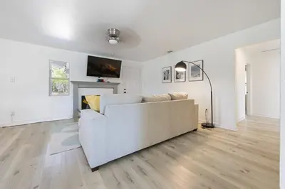 a white living room with a couch and a fireplace at Luxury Home with Spacious Backyard - Sleeps 12 in Poway