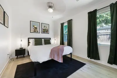 a bedroom with a bed and a large window at Luxury Home with Spacious Backyard - Sleeps 12 in Poway