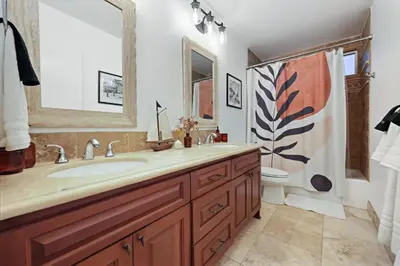 a bathroom with a sink and a toilet at Hot Tub with A View and Large Back Deck & Game Room in Poway