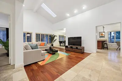 a living room with a couch and a flat screen tv at Hot Tub with A View and Large Back Deck & Game Room in Poway