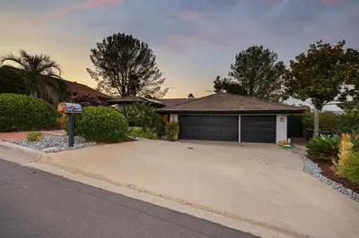 a house with a parking meter in front of a driveway at Hot Tub with A View and Large Back Deck & Game Room in Poway