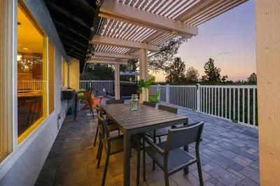 a wooden table and chairs on a patio at Hot Tub with A View and Large Back Deck & Game Room in Poway