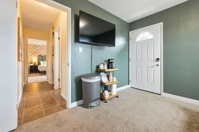 a hallway with green walls and a white door at 10 Mins to the Beach La Jolla and UCSD in San Diego